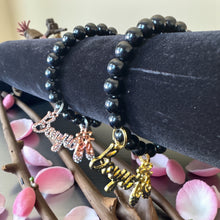 Load image into Gallery viewer, 8mm Black Beaded Bracelet with Boujie and Shoes Charms
